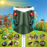 Solar-powered animal deterrent device with red lights and sound waves on a garden background.