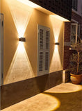 Solar Wall Lamp, Up & Down LED Light, on a building facade.