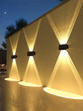 Solar Wall Lamp, Up & Down LED Light, Modern outdoor wall lights on a textured wall at night
