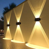Solar Wall Lamp, Up & Down LED Light, Outdoor Waterproof Colour Changing Light on a building facade with a warm glow